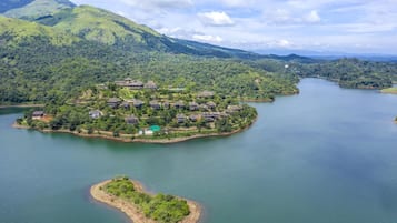 Escape to a serene lakeside retreat, surrounded by lush green hills and tranquil waters.
