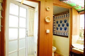 Bathroom with a decorative patterned wall, toilet, and sink.