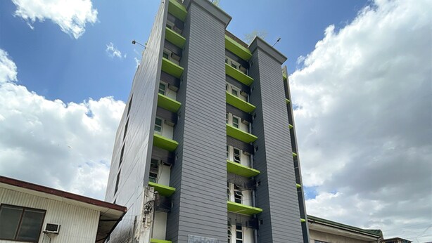 A multi-story building with balconies, a clear sky, and clouds. - H Hotel Quezon City (Quezon City)