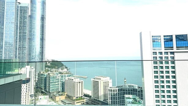 A person relaxing in a pool with a cityscape view.