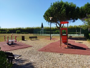 Enjoy outdoor recreation with a seesaw, swing set, and climbing structure, plus a bench for relaxation.
