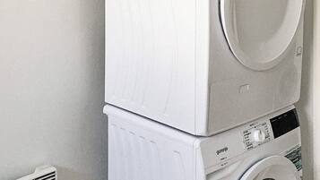 A stacked washer and dryer unit with a control panel.