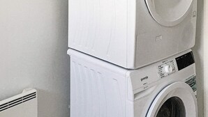 A stacked washer and dryer unit in a laundry room. - 5 Star Holiday Home in Nakskov (Nakskov)