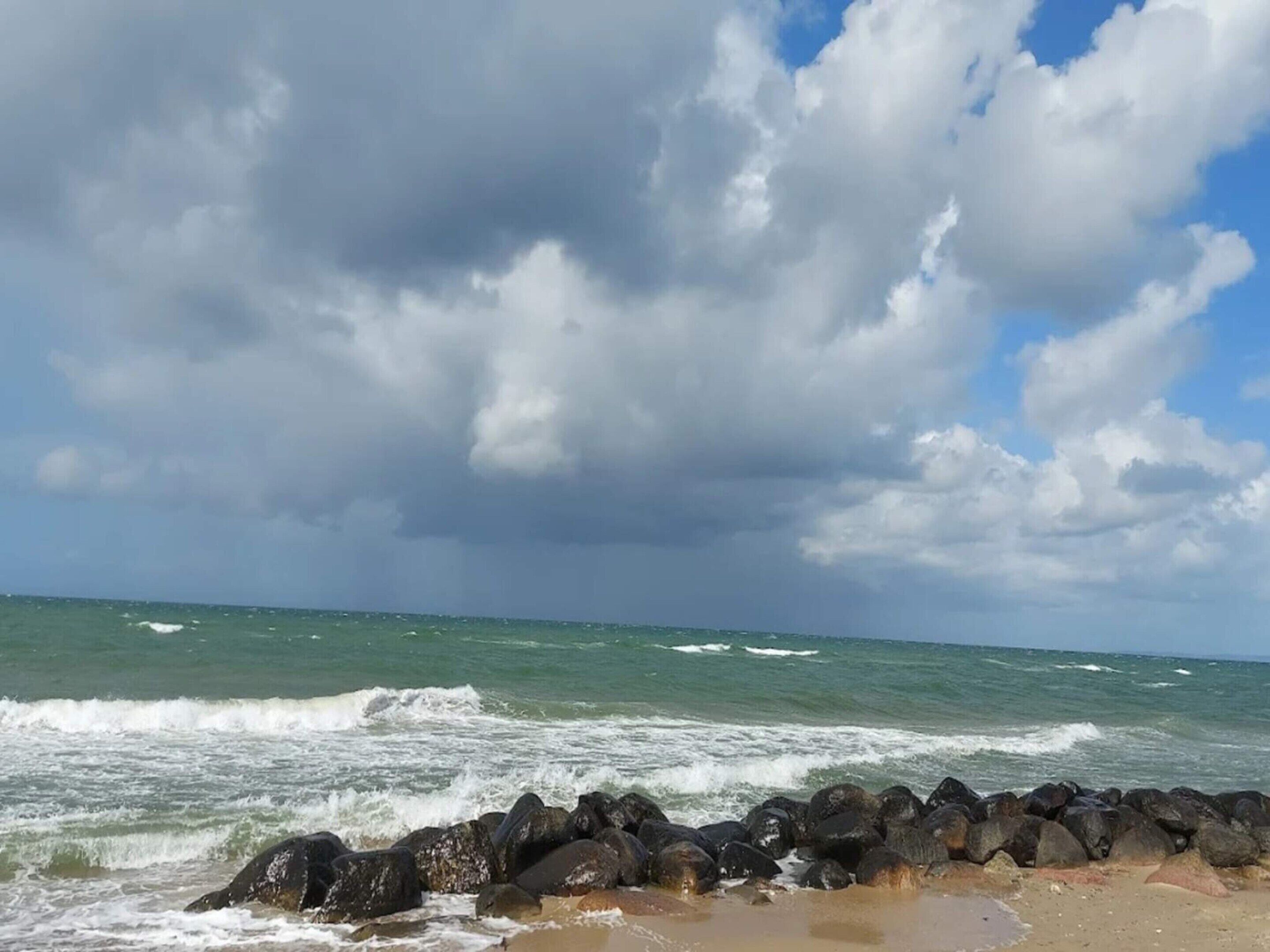 A rocky shoreline with waves crashing against the rocks.