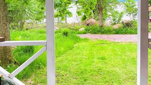 A wooden deck with a grill and a grassy area in the background. - 4 Person Holiday Home in Braas-by Traum (Braås)