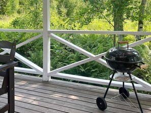 A wooden deck with a grill and a bench. - 4 Person Holiday Home in Braas (Braås)