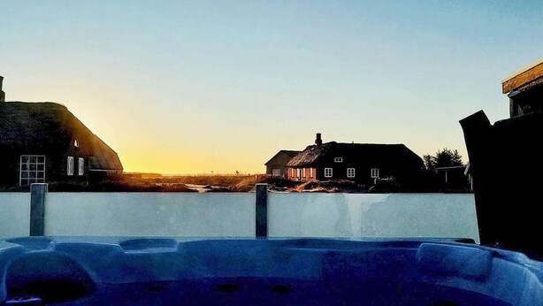 A swimming pool with a view of houses and a clear sky. - 6 Person Holiday Home in Ringkobing (Ringkobing)