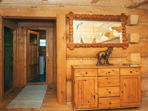 A wooden cabin interior with a wooden cabinet, a decorative elephant sculpture, and a mirror on the wall. - 8 Person Holiday Home in Ebeltoft (Ebeltoft)