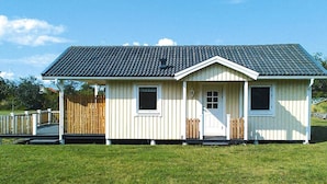 A small, single-story building with a gabled roof and a front door. - 4 Person Holiday Home in Byxelkrok (Byxelkrok)