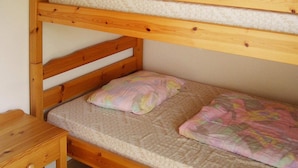 A bunk bed with a wooden frame and a single bed below. - 4 Person Holiday Home in Byxelkrok-by Traum (Byxelkrok)