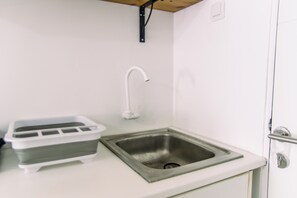 Enjoy cooking in this kitchen with a stainless steel sink, modern faucet, and ice tray.