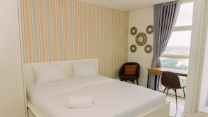 Een hotelkamer met een groot bed, een bureau en een stoel.