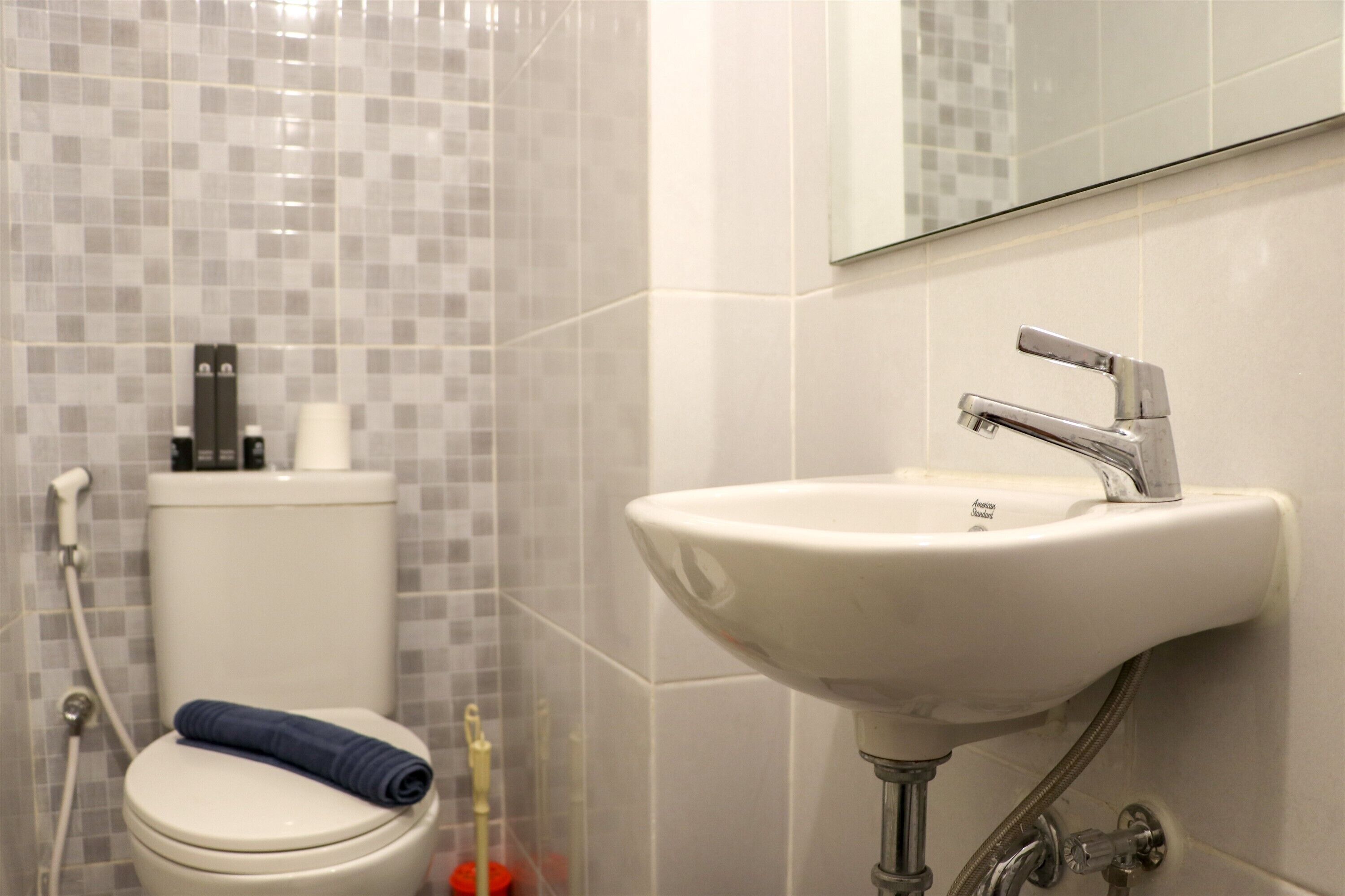 A bathroom with a toilet, sink, and shower.