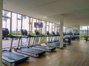 Work out with a view at this gym, featuring a row of treadmills and large windows.