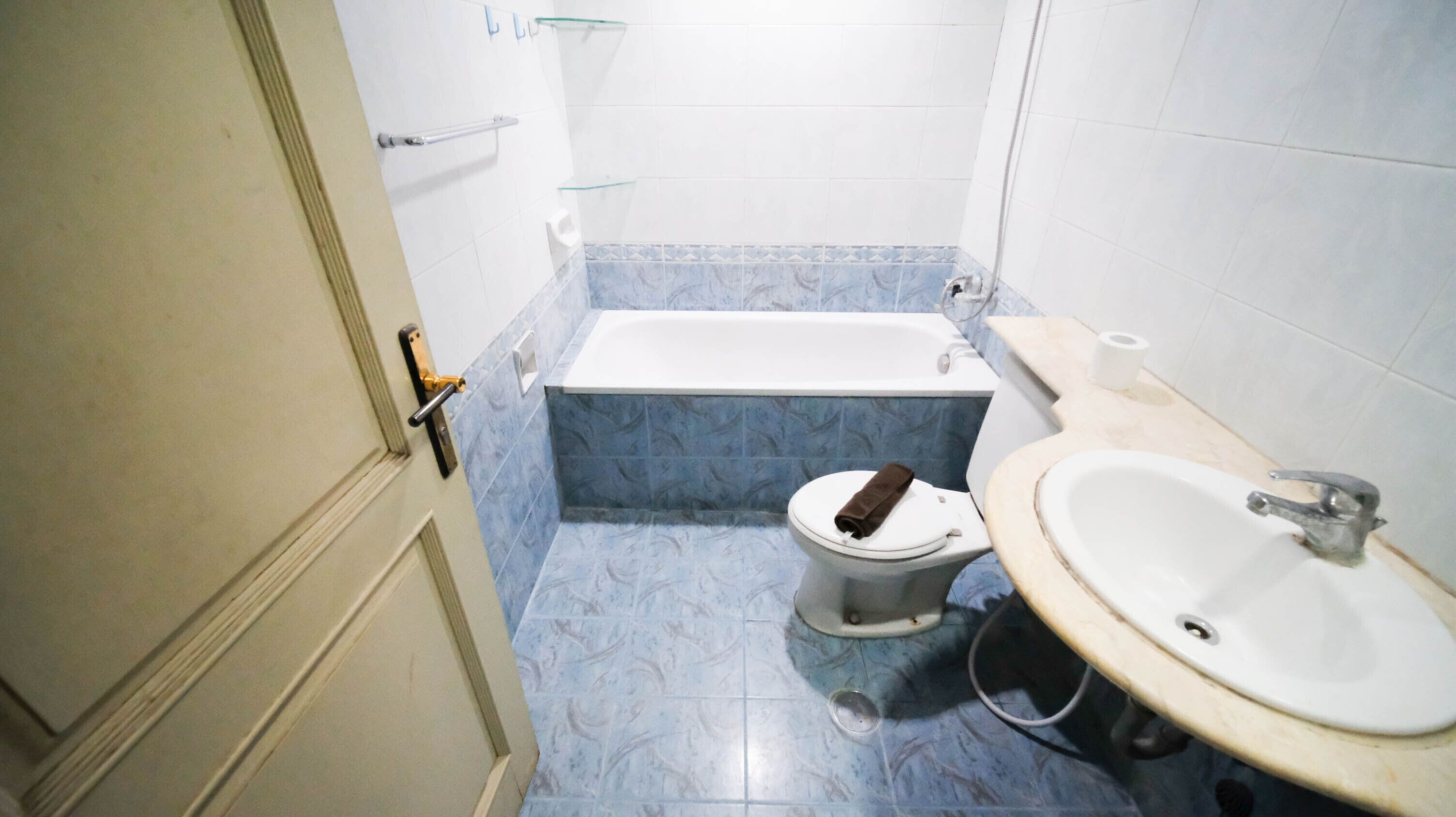 A small bathroom with a toilet, bathtub, and sink.