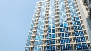 A high-rise building with a grid of balconies and windows. - Strategic And Well Designed Studio Apartment At Capitol Park Residence (Jakarta)