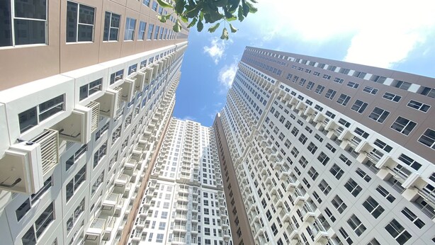 A high-rise building with multiple floors, large windows, and balconies. - Chic And Cozy Studio Tokyo Riverside Pik 2 Apartment (Teluknaga)