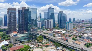 A cityscape with modern high-rise buildings, a highway, and a mix of residential and commercial areas. - Restful And Comfortable Studio At Ciputra World 2 Apartment (Jakarta)
