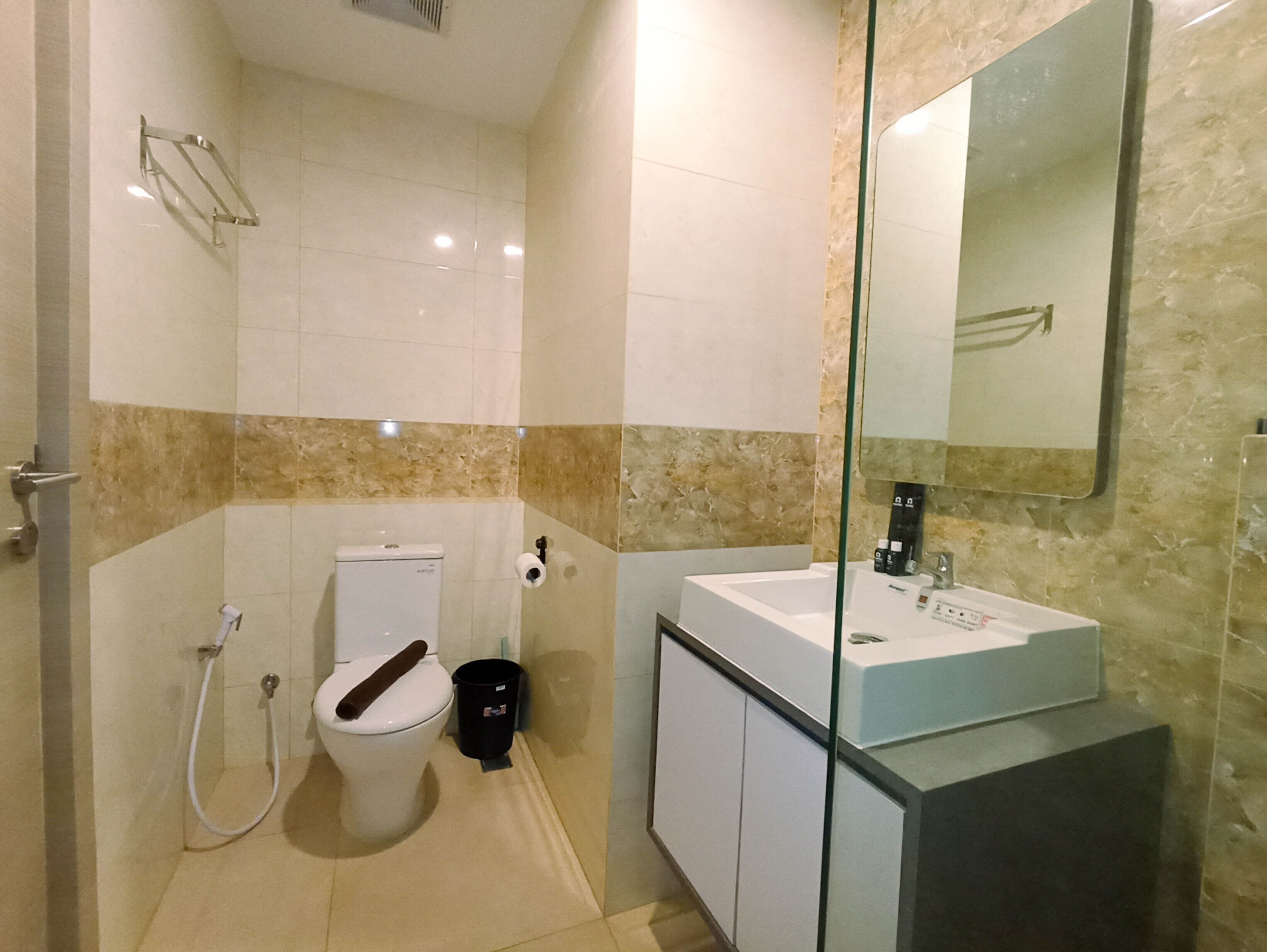 A modern bathroom with a toilet, bidet, and sink.