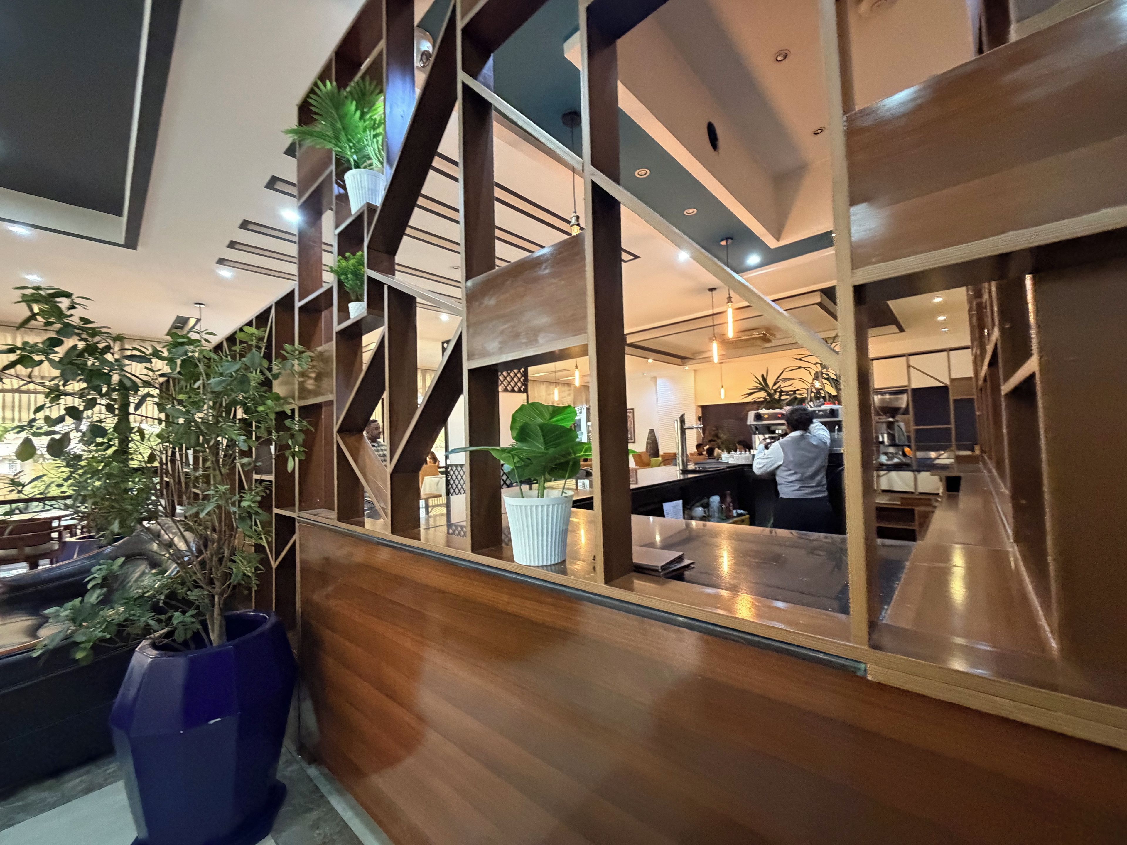 A modern interior with wooden paneling, a seating area, and a bar counter.