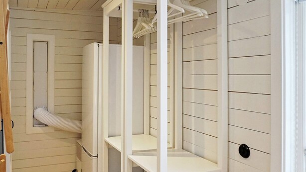 A room with a white wardrobe, a small window, and a wooden floor. - 4 Person Holiday Home in Grisslehamn (Grisslehamn)