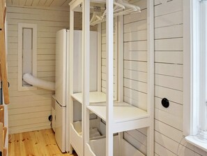 A room with a white wardrobe, a small window, and a wooden floor. - 4 Person Holiday Home in Grisslehamn (Grisslehamn)