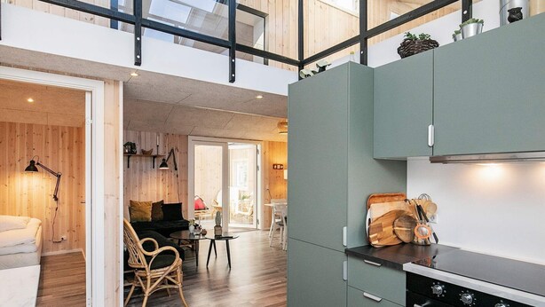 Una cucina moderna con forno integrato e zona pranzo con tavolo e sedie.