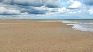 A wide sandy beach with a cloudy sky. - 5 Star Holiday Home in Vaeggerlose (Vaeggerlose)