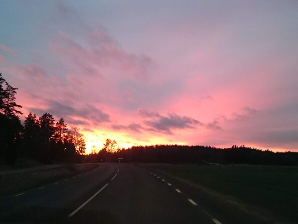 A road with a sunset in the background.