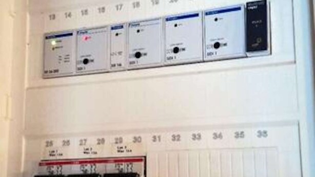 A control panel with numbered switches and a thermostat.