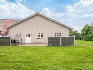 A single-story brick building with a flat roof, a front door, and two windows.