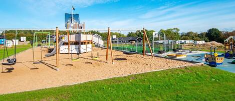 A playground with swings, slides, and a climbing structure.