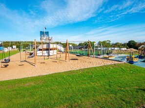 A playground with swings, slides, and a ship-themed play structure. - 5 Star Holiday Home in Sydals (Sydals)
