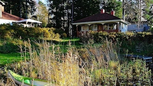 A canoe in a marshy area with houses in the background. - 2 Person Holiday Home in Bengtsfors-by Traum (Bengtsfors)