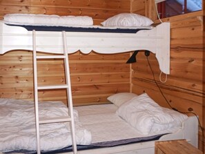 A bunk bed with a ladder, white bedding, and a wooden wall. - 4 Star Holiday Home in Salen (Salen)