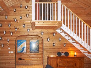 A wooden interior with a staircase, wooden walls, and mounted animal skulls. - 4 Star Holiday Home in Salen (Salen)