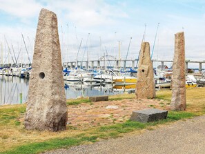 A marina with boats docked, stone pillars, and a bridge in the background. - 6 Person Holiday Home in Rudkobing (Rudkobing)