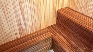 A corner of a room with wooden paneling and a built-in bench.
