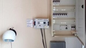 A wall-mounted electrical panel with a control panel and a white device, possibly a thermostat, connected by wires. - 4 Person Holiday Home in Romo (Rømø)
