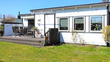 A single-story house with a front porch, a small deck, and a number 2723 on the house.