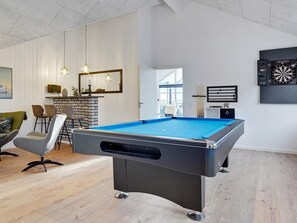 A modern living room with a pool table, seating area, and billiards equipment. - 5 Star Holiday Home in Sydals (Sydals)