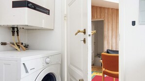 A laundry room with a washing machine, a dryer, and a control panel. - 4 Person Holiday Home in Ega (Aarhus)