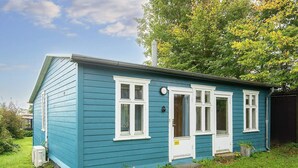 A small, single-story house with a gabled roof, a front door, and a small porch. - 4 Person Holiday Home in Ega (Aarhus)