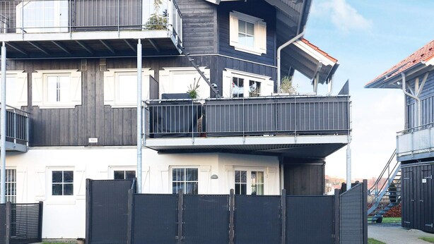 A multi-story residential building with balconies, a gated entrance, and a visible staircase. - 5 Person Holiday Home in Bogense (Bogense)