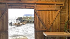 A wooden cabin with a view of a dock and boats. - 4 Star Holiday Home in Svelgen (Bremanger)