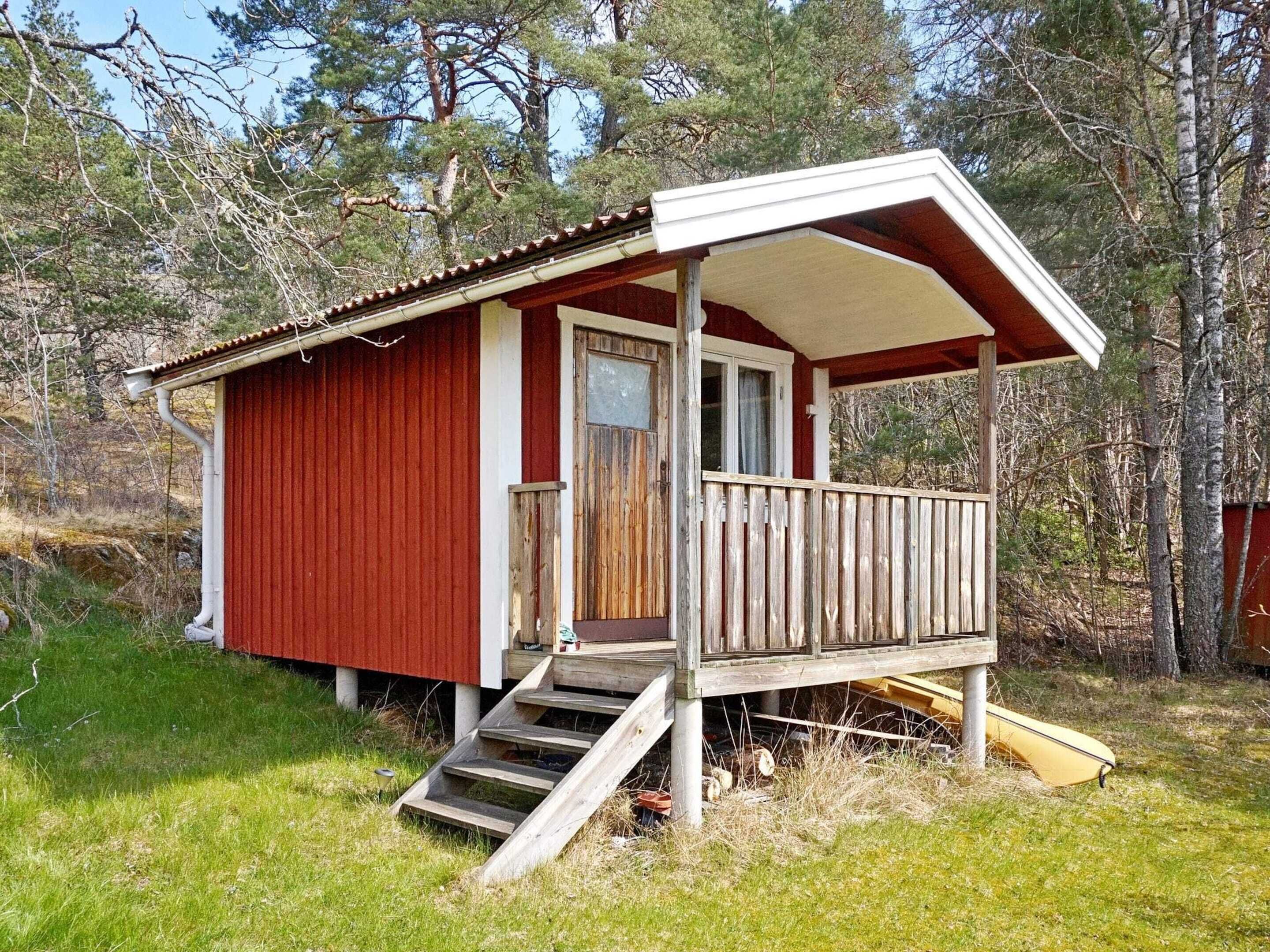 A small cabin with a porch, wooden steps, and a door.