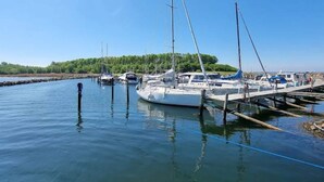 Un puerto deportivo con varios veleros amarrados a muelles de madera.