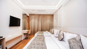 A hotel room with a bed, a desk, a chair, and a television. - HOTEL EUPHORIA GREEN (Amritsar)