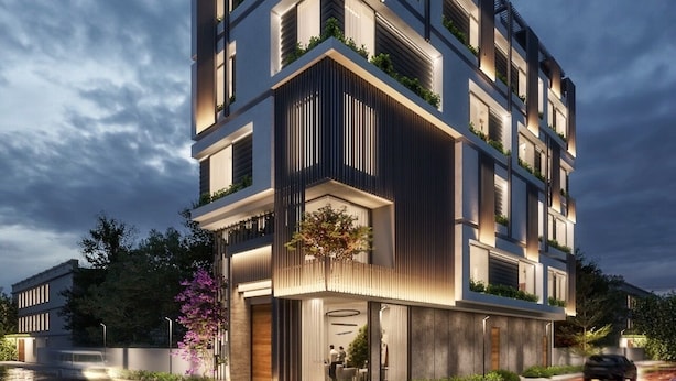 A modern multi-story building with balconies, large windows, and a well-lit entrance. - HOTEL EUPHORIA GREEN (Amritsar)