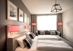 A hotel room with a large bed, two bedside lamps, a headboard, and a window with curtains. - Myrkdalen Resort Hotel (Voss)